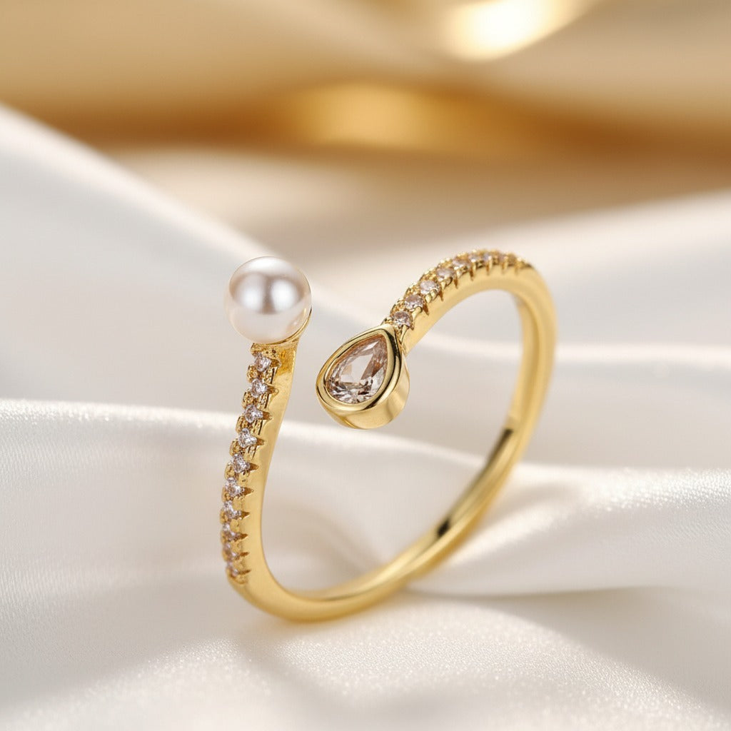 Gold ring with a pearl and diamond on a white fabric background