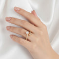 Hand wearing a pearl ring on a white background